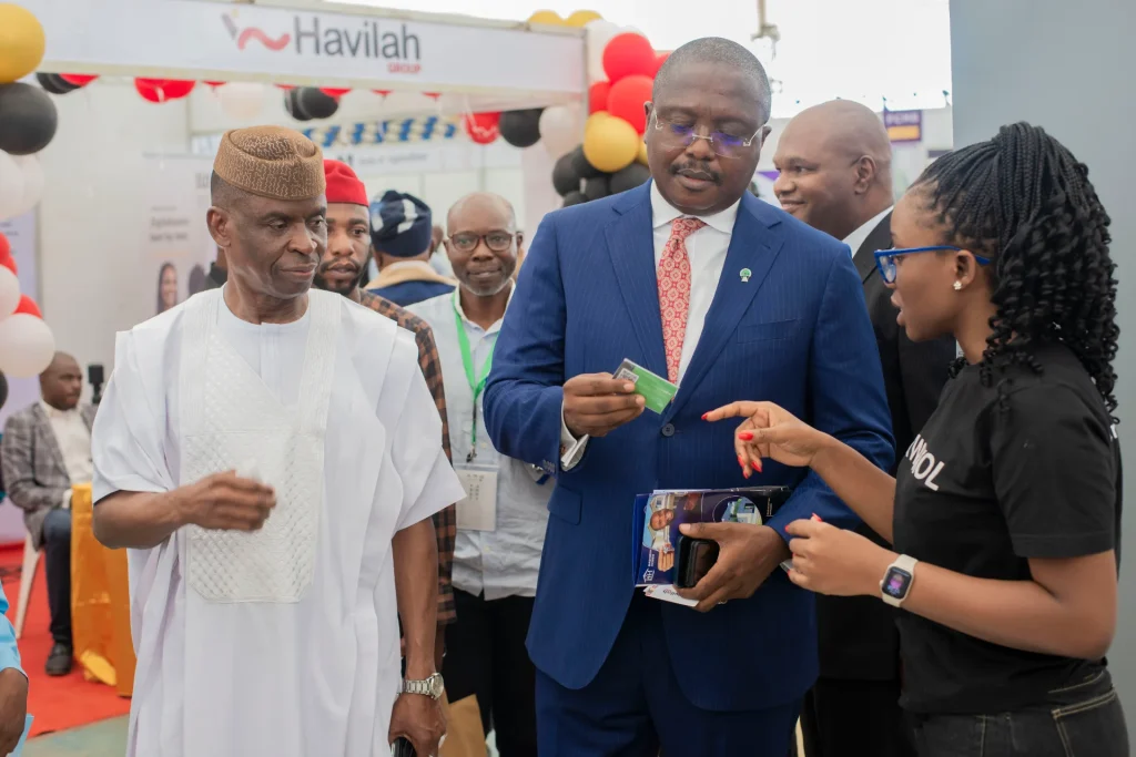 Visitors speaking with an exhibitor beside a product display