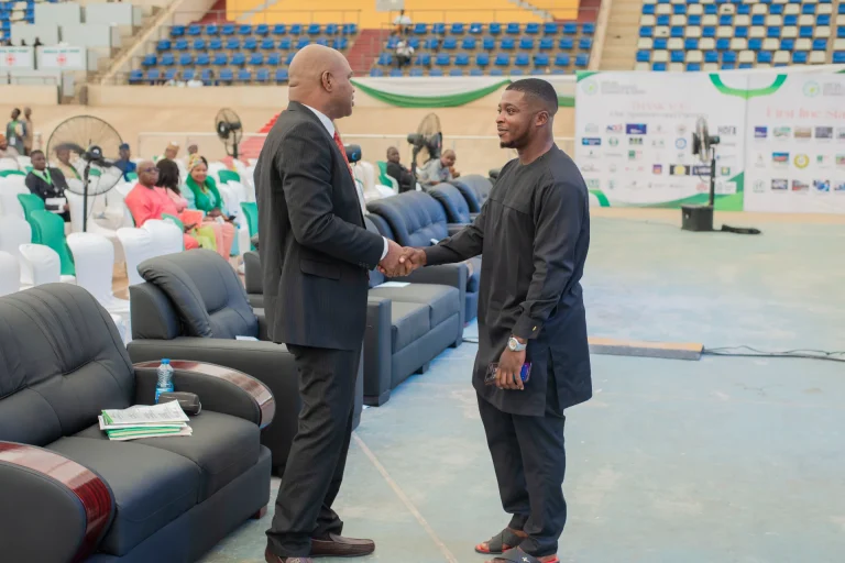 Two attendees greeting each other at the summit