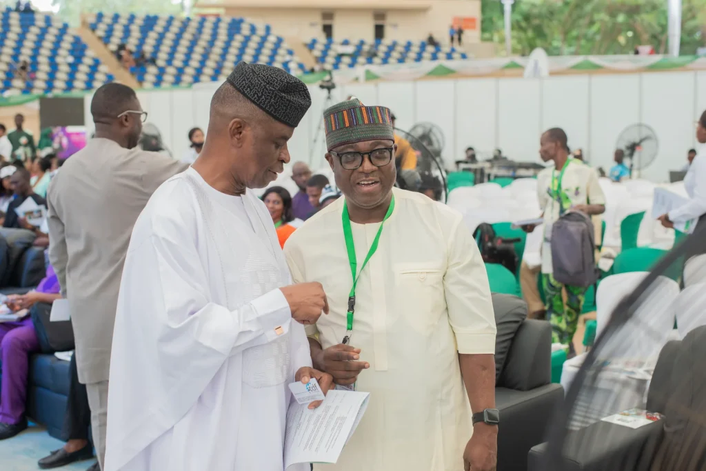 Two summit attendees talking in the event hall