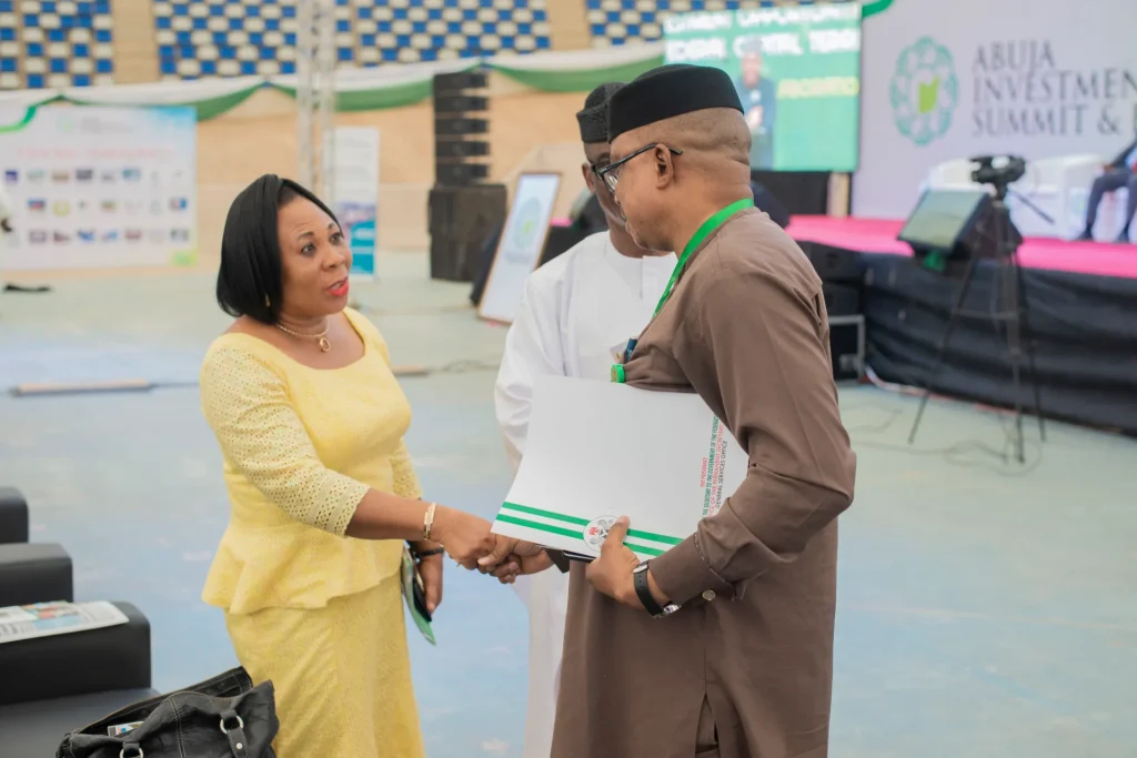 Two event attendees exchanging a document during a conversation